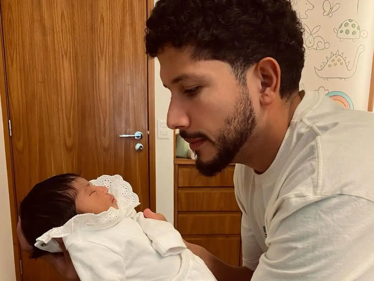 IZA: Nala's father, Yuri Lima, opens a photo album with his daughter